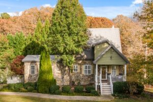 Beautiful stone cottage nestled among trees, representing the ideal countryside home ready for sale in the UK