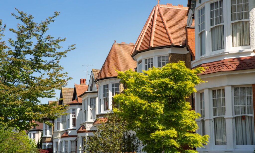 Row of traditional period houses with bay windows and red-tiled roofs on a sunny day in Ampthill, Bedfordshire.