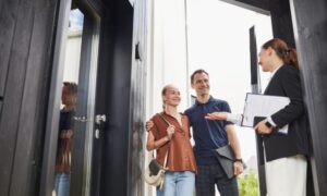 Couple speaking with estate agent during a house viewing, representing the spring property market in Hertfordshire and Bedfordshire.