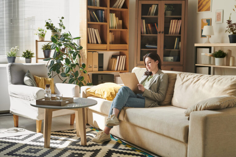 Woman working from home in a modern living room with natural light