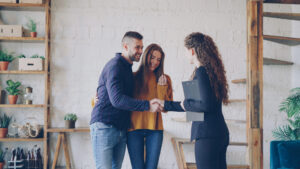 Landlord meeting tenants and finalising rental agreement in a modern home