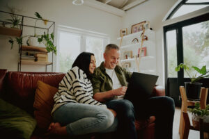 A couple researching homes online together in preparation for buying a property in Ickleford.