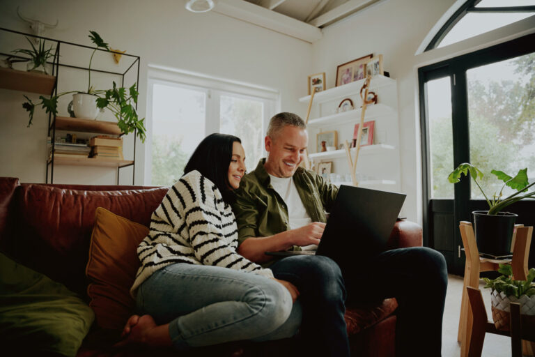 A couple researching homes online together in preparation for buying a property in Ickleford.