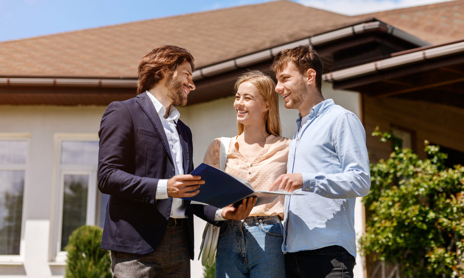 Couple speaking with a property agent outside a home while searching for property in Hitchin’s SG4 and SG5 area.
