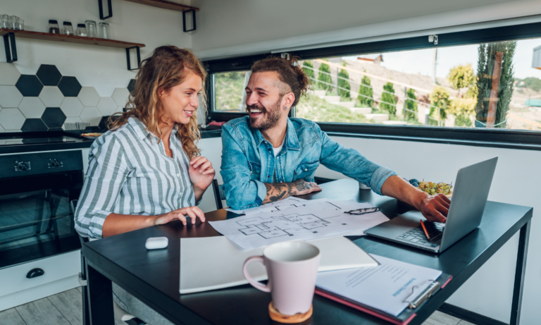 Couple shaking hands with an estate agent during a property viewing near Hitchin.