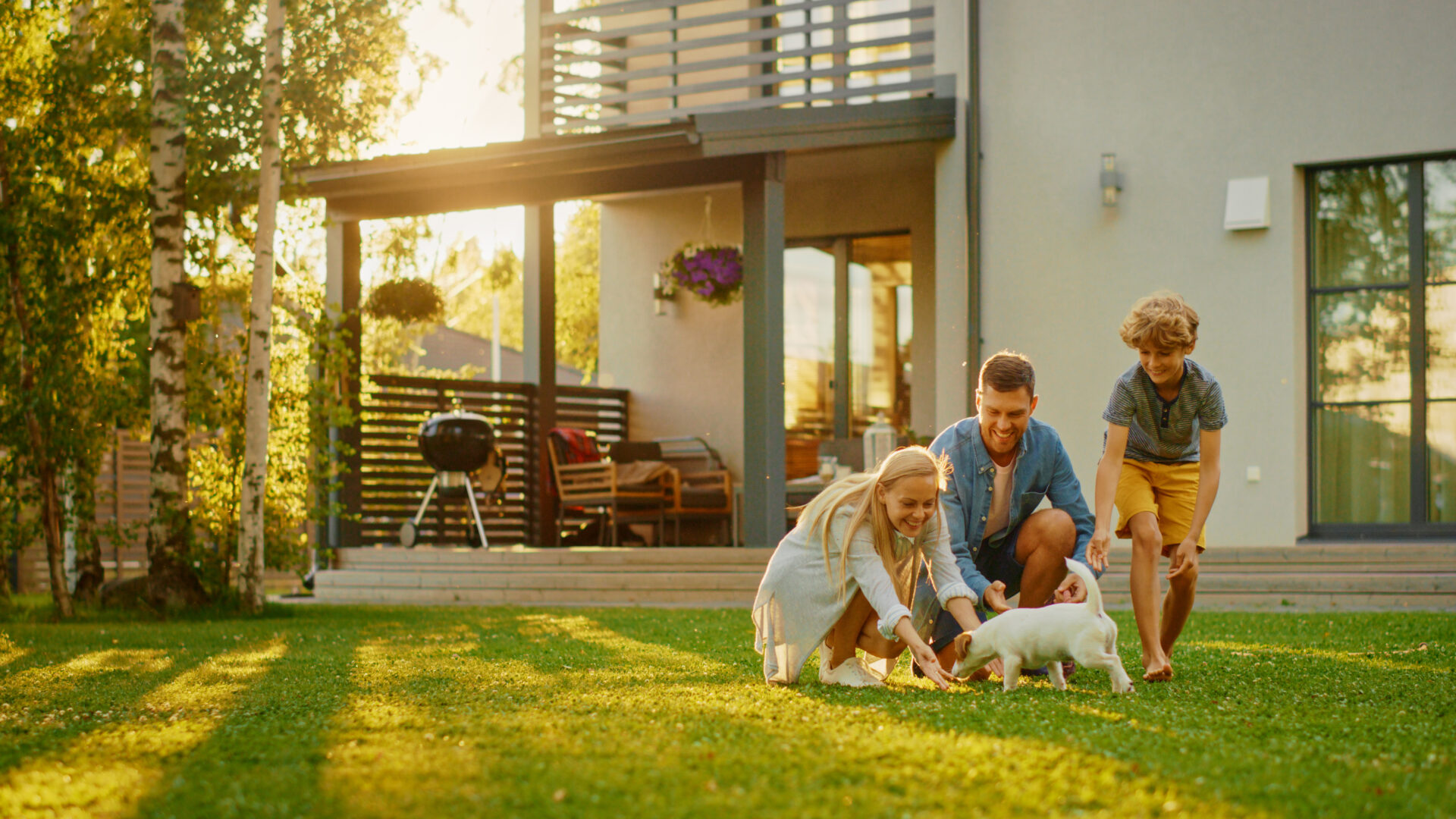 Family enjoying the garden of a modern home in Hertfordshire