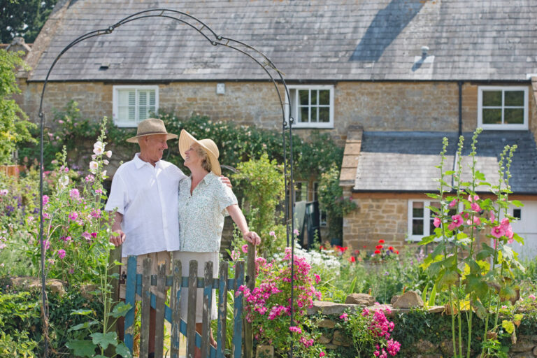 Senior couple reviewing their country property plans in the garden